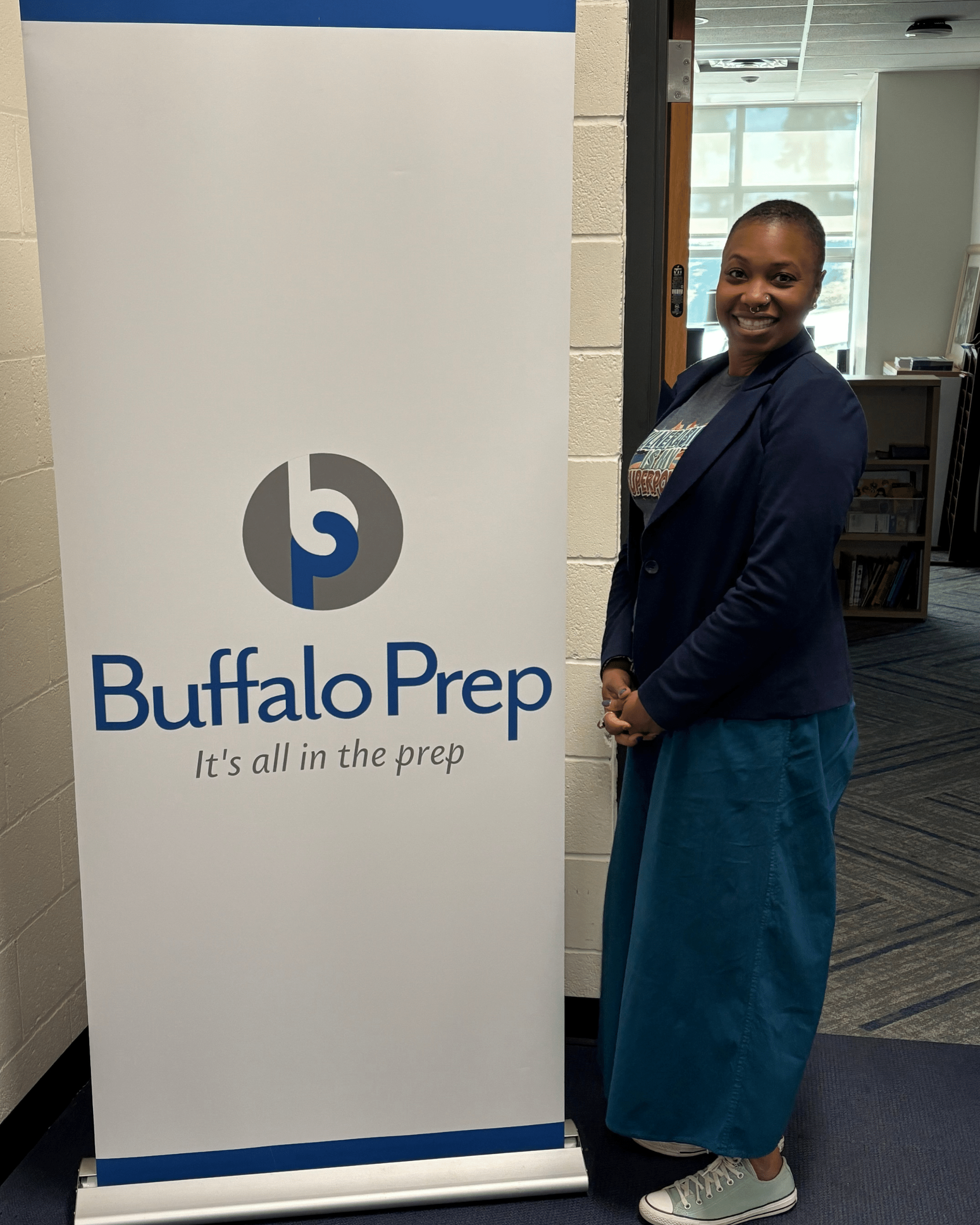 Dr. Dominique Hill at a Buffalo Prep banner during YPAR launch activities